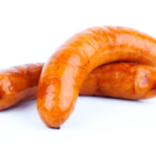 Stack of cooked sausages on a white background